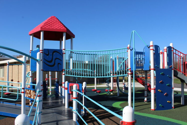 playground equipment with a ramp and rock wall