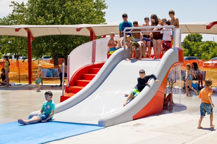 kids sliding down wide water slide