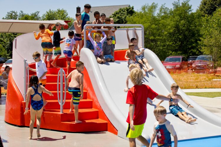 children waiting in line to go down wide water slide