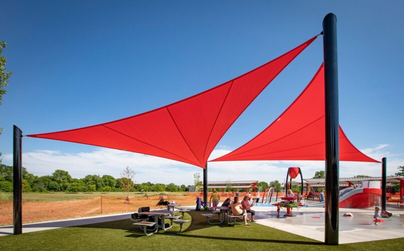 two large sunshades above picnic table area